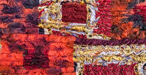 Ornament of red brown patchwork scarf ornament of stitched crumpled red br... Stock-Fotos