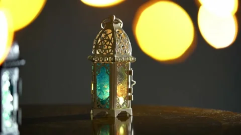 Ornamental Arabic lantern with burning candle glowing at night and glittering Stock Footage 146365320