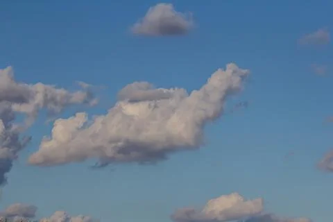 Ornamental clouds. Dramatic sky. Epic storm cloudscape Soft sunlight. Panoram Stock Photos