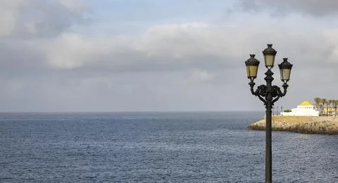 Ornate art deco black Cast iron street lights in the Spanish city of Cadiz. Stock Photos