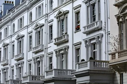 Ornate balconies and windows frames of old style apartment building Stock Photos