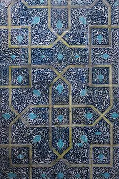 Ornate blue ceramic tilework with arabesque patterns at Pahlavan Mahmud Mau.. Stock Photos