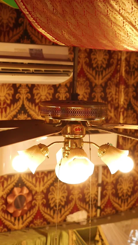 Ornate Brass Ceiling Fan and Lighting in Bangkok Indian Restaurant Stock Footage 340194480