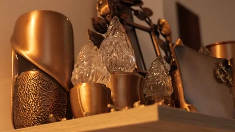 Ornate candle holders, warm light, detail shot, shelf display view Stock Footage 293462872