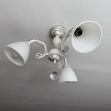 Ornate ceiling light fixture with three lamps Stock-Fotos