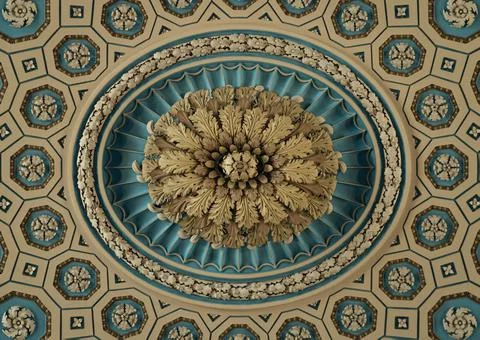 An ornate, classical ceiling features a brilliant teal and gold oval medall.. Stock Photos