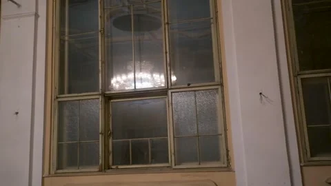 Ornate classical chandelier glows in old ball room Stock Footage 337798943