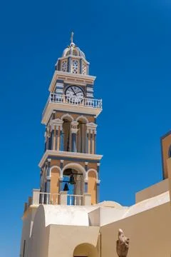Ornate clock tower of Saint John the Baptist Cathedral in Fira Santorini Stock Photos