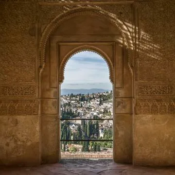 Ornate detail on an interior wall facade with a view of the town of Granada Stock Photos