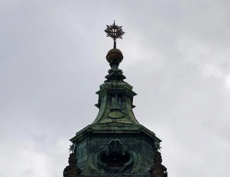 Ornate dome with decorative elements. Crowned cupola under cloudy sky with .. Stock Photos
