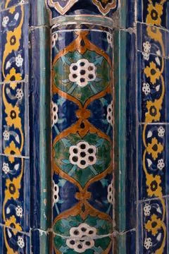 Ornate glazed ceramic tilework on a column at Poi Kalyan complex in Bukhara.. Stock Photos