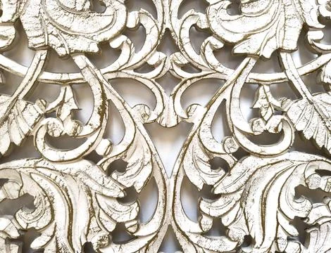 Ornate gold carved scrollwork forms symmetrical decorative pattern with tex.. Stock Photos