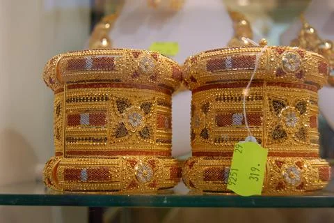 Ornate gold cuff bangles on display in a Tripoli Jewellery Shop Stock Photos