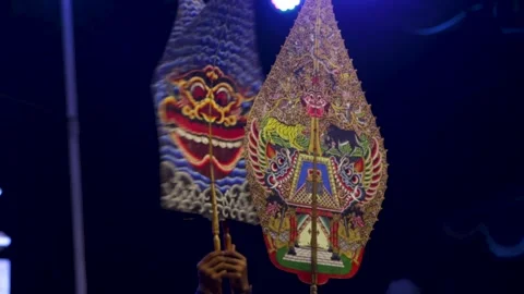 Ornate gunungan leather puppet held during traditional wayang performance a.. Stock Footage 344826537
