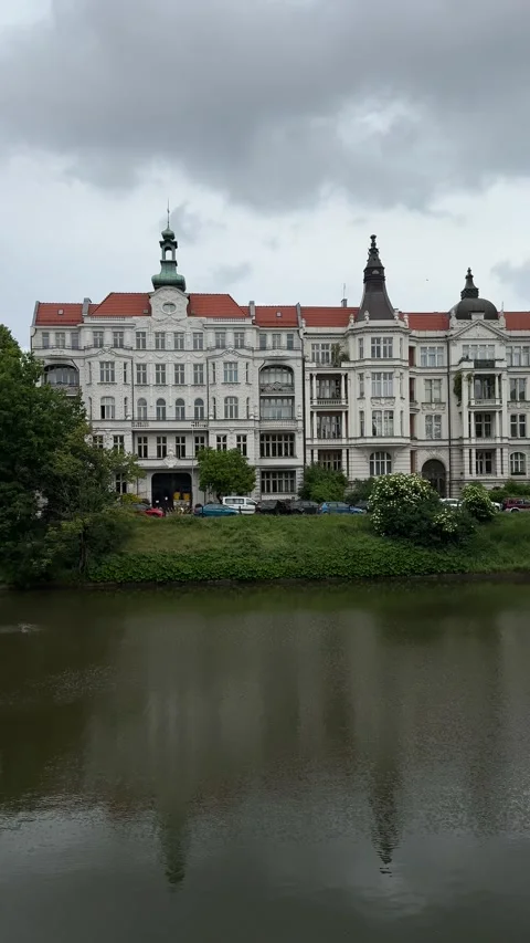 Ornate historic building with red rooftops reflected in river in Wroclaw, Poland Stock Footage 310796968