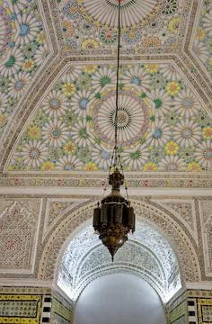 Ornate Islamic Stucco Ceiling with Polychrome Rosettes and Brass Lantern Stock Photos