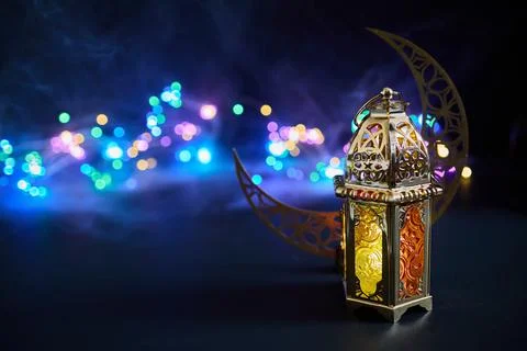 Ornate lantern and crescent moon celebrating ramadan Stock Photos