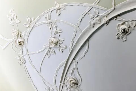 Ornate plaster ceiling relief showcasing delicate rose motifs Stock Photos