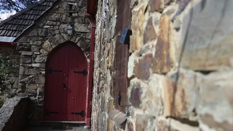 Ornate red door on an old stone church building Stock Footage 341918385