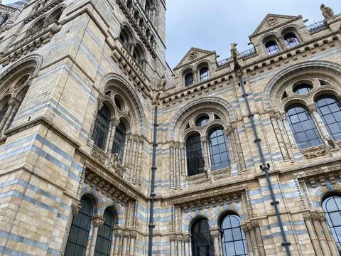 Ornate Romanesque Stone Facade with Arched Windows, Low Angle View Stock Photos