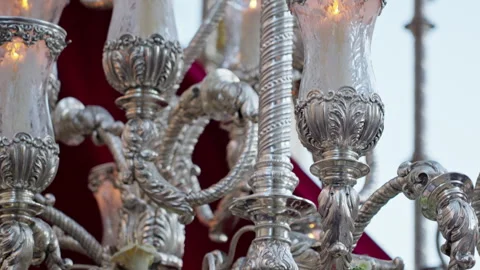Ornate silver candelabra on a Holy Week float during a religious procession Stock Footage 333880231