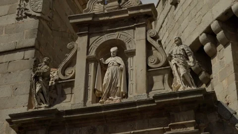 Ornate stone facade featuring three religious statues standing in niches, d.. Stock Footage 335640689