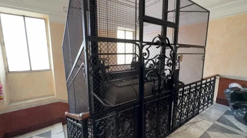 Ornate vintage elevator with wrought iron details in an old building Stock Footage 285601498