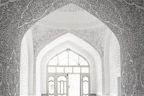 Ornate white plaster arches inside Muhammad Amin Khan Madrasa in Khiva, Uzb.. Stock Photos