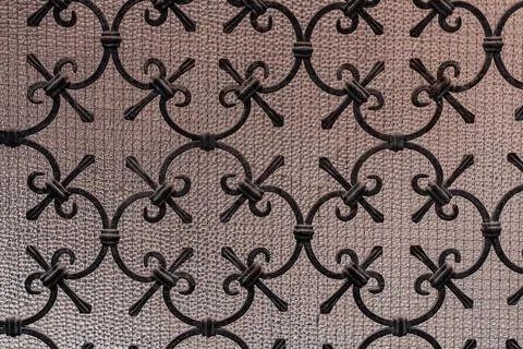 Ornate wrought iron scrollwork pattern on textured glass background Stock Photos