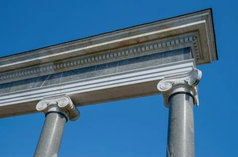 Ornately decorated Ionic  columns with blue sky. Stock Photos