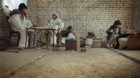 Orphans Inside Abandoned Building Playing Chess Caring Cooking and Carving Wood Stock Footage 317695787
