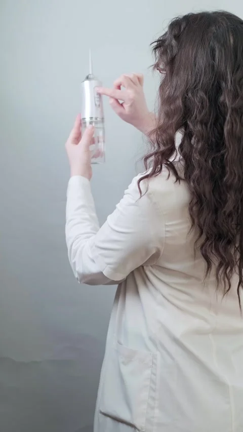 Orthodontist explains how using an irrigator helps patients maintain long-term Stock Footage 307305105