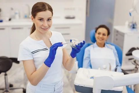 Orthodontist posing at camera with jaws model Stock Photos