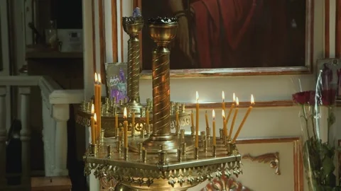 Orthodox candles, bathed in soft light, create a serene atmosphere within th Vídeos de archivo 309665277