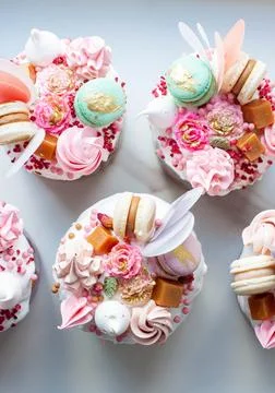 Orthodox easter bread called Kulich, richly decorated with sweets, macaroon.. Stock Photos
