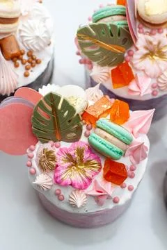 Orthodox easter bread called 'Kulich' richly decorated with sweets, macaroons Stock Photos