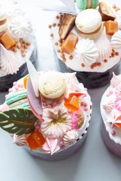 Orthodox easter bread called 'Kulich' richly decorated with sweets, macaroons Stock Photos