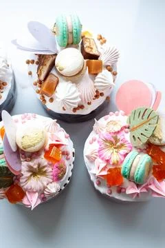 Orthodox easter bread called 'Kulich' richly decorated with sweets, macaroons Stock Photos