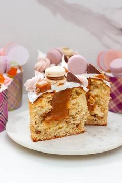 Orthodox easter bread richly decorated with sweets, macaroons, chocolate and  Stock Photos