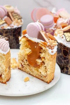 Orthodox easter bread richly decorated with sweets, macaroons, chocolate and  Stock Photos