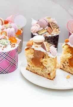 Orthodox easter bread richly decorated with sweets, macaroons, chocolate and  Stock Photos