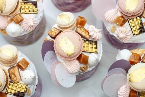 Orthodox easter bread richly decorated with sweets, macaroons, chocolate an.. Stock Photos