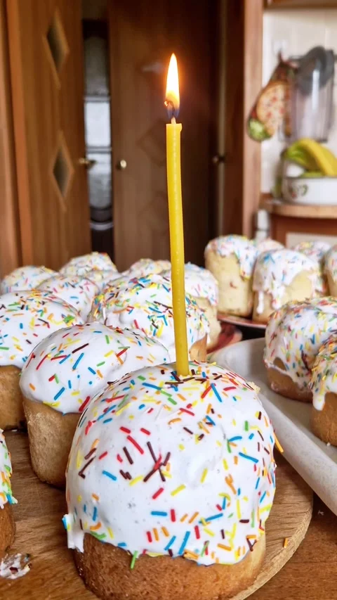 Orthodox Easter Kulich Cakes with Lit Candle on Wooden Table Stock Footage 339003821