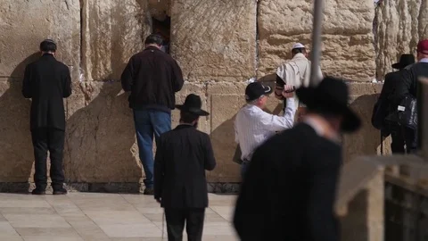 Orthodox jew praying in front of wester wall Stock Footage 80380620