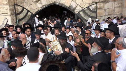 Orthodox Jews dance around a Torah scroll, Western Wall in Jerusalem, Israel Stock Footage