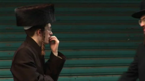 Orthodox Jews talk in the street in Haifa, Israel. Stock Footage