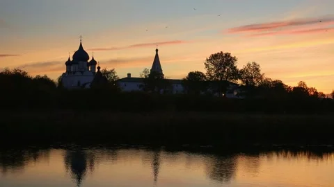 Orthodox monastery at sunset with reflection in water. Russia Stock Footage 304817839