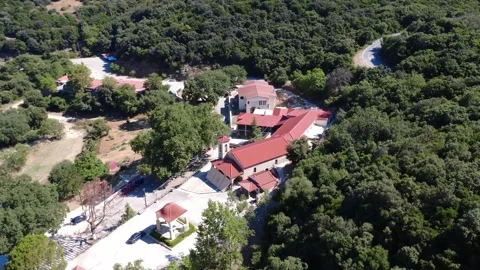 Orthodox monastery tower with cross above Mediterranean hillside in Greece Video stock 317296570