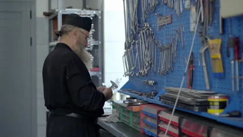 Orthodox monk choosing tools in workshop at Mount Athos Stock Footage 330195201