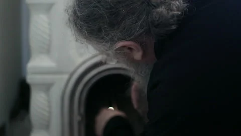 Orthodox monk lighting a traditional ceramic stove Stock Footage 330197477